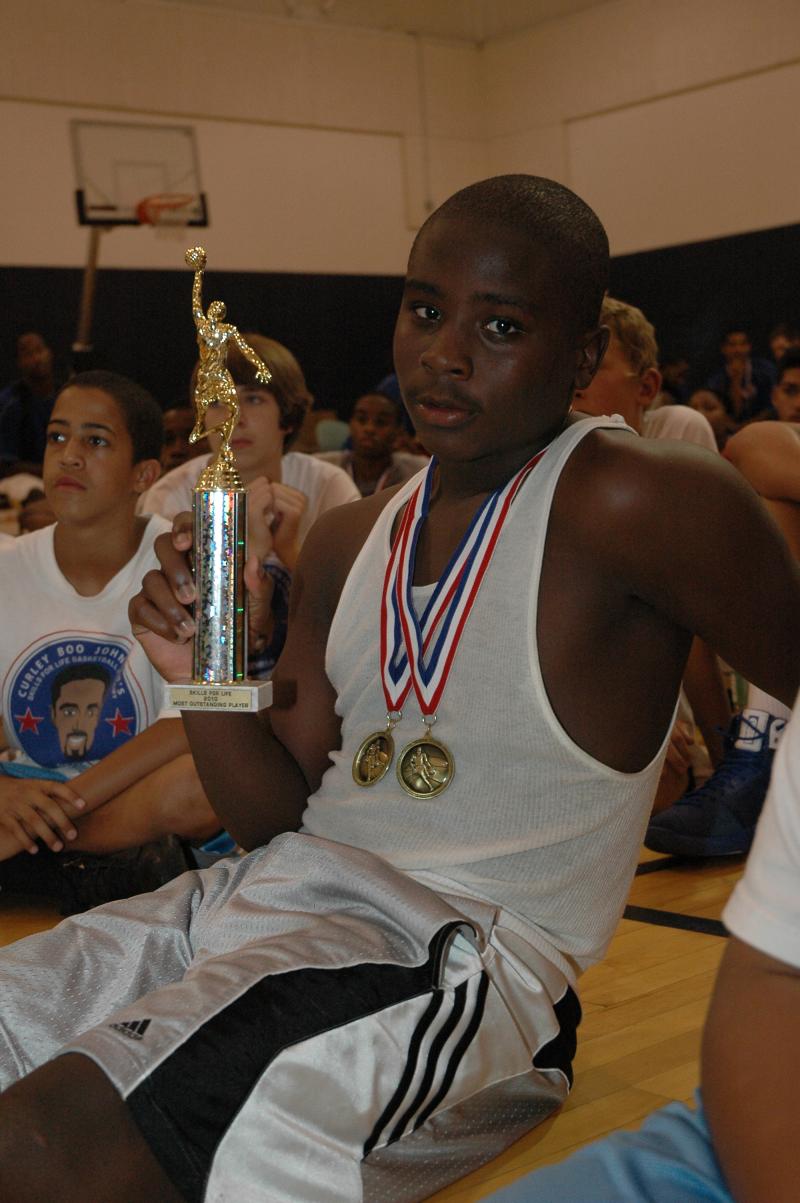 Aaron Sanders with his championship medals and Most Outstanding Player trophy.